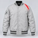Stone gray SPEAK//UP varsity bomber jacket with a white arrow patch, red shoulder artwork and striped ribbing, front view