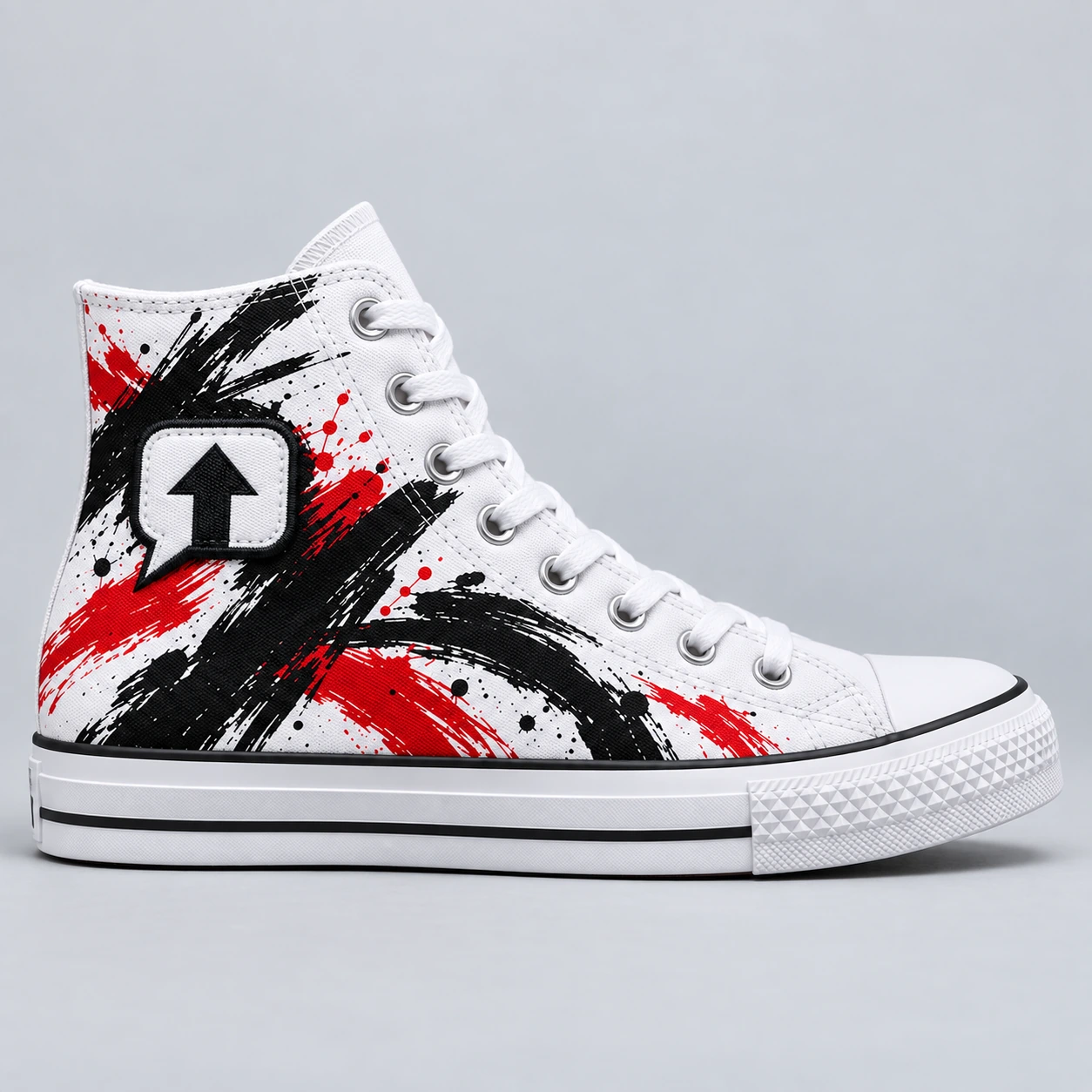 White SPEAK//UP canvas high-top sneaker with red and black artwork and a sewn arrow patch with a black embroidered border, side view.
